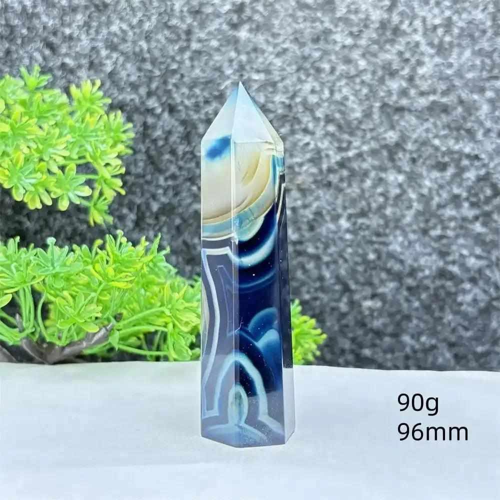 Polished blue agate hexagonal tower with soft blue banding, perfect for Throat Chakra healing and calming desk decor.