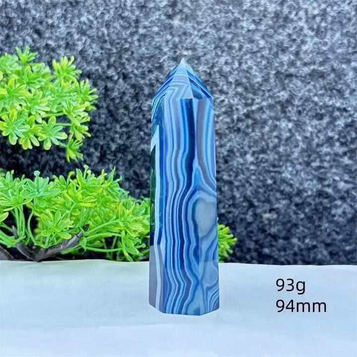 Polished blue agate hexagonal tower with soothing blue banding, perfect for throat chakra healing and calm communication.