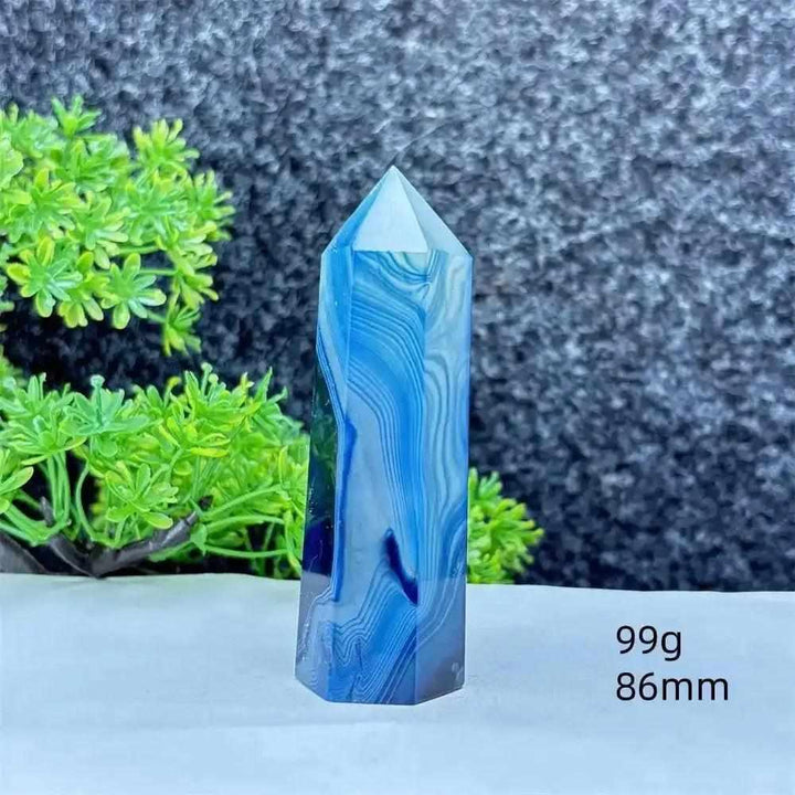 Polished blue agate hexagonal tower with soothing blue banding, perfect for throat chakra healing and calm focus.