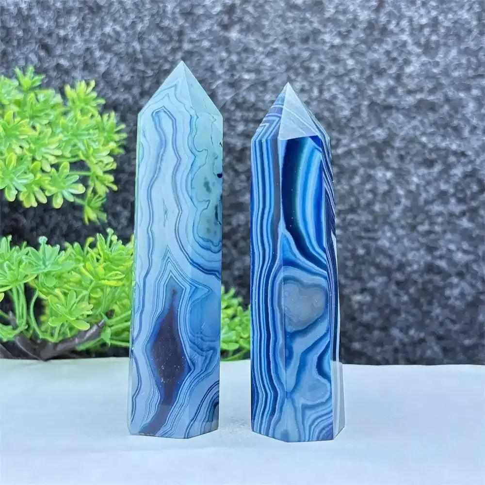 Polished blue agate hexagonal towers with soothing blue banding, perfect for throat chakra healing and calm focus.