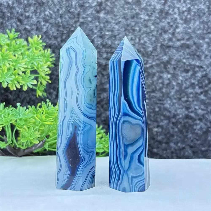Polished blue agate hexagonal towers with soothing blue banding, perfect for throat chakra healing and calm focus.