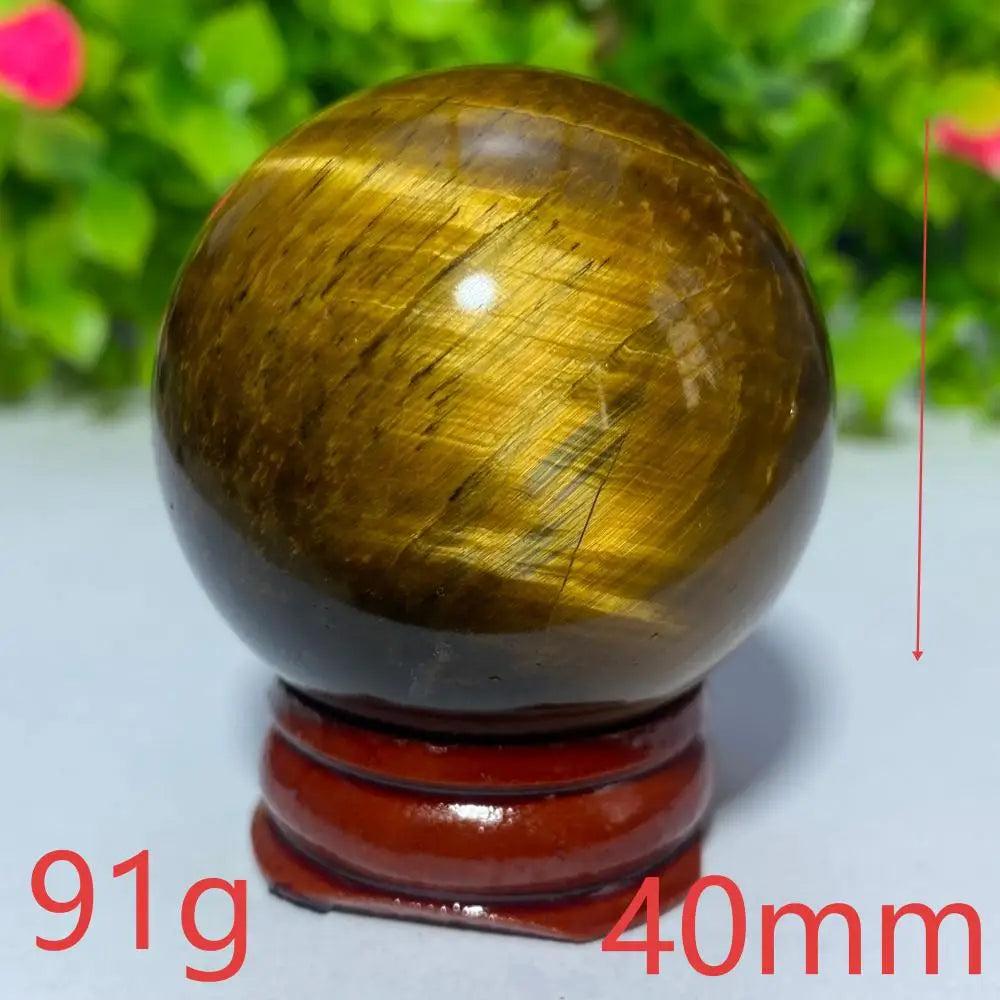 40mm Natural Blue Yellow Tiger Eye crystal ball for Reiki healing and meditation, featuring a polished golden sphere.