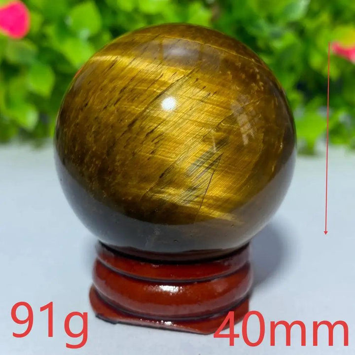 40mm Natural Blue Yellow Tiger Eye crystal ball for Reiki healing and meditation, featuring a polished golden sphere.
