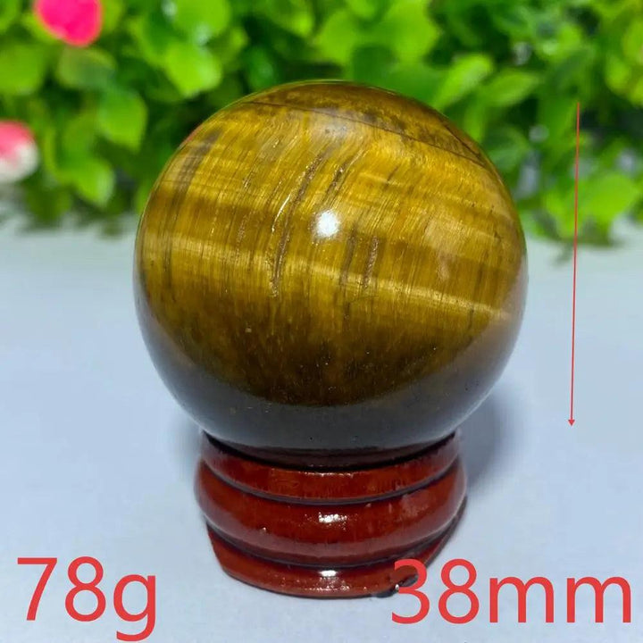 38mm Natural Yellow Tiger Eye crystal ball on a wooden stand, perfect for Reiki healing, meditation, and home decor.
