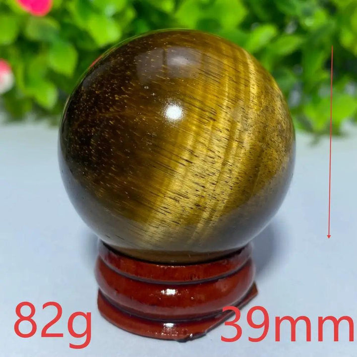 39mm natural Tiger Eye crystal ball on a wooden stand, perfect for Reiki healing, meditation, and spiritual home decor.
