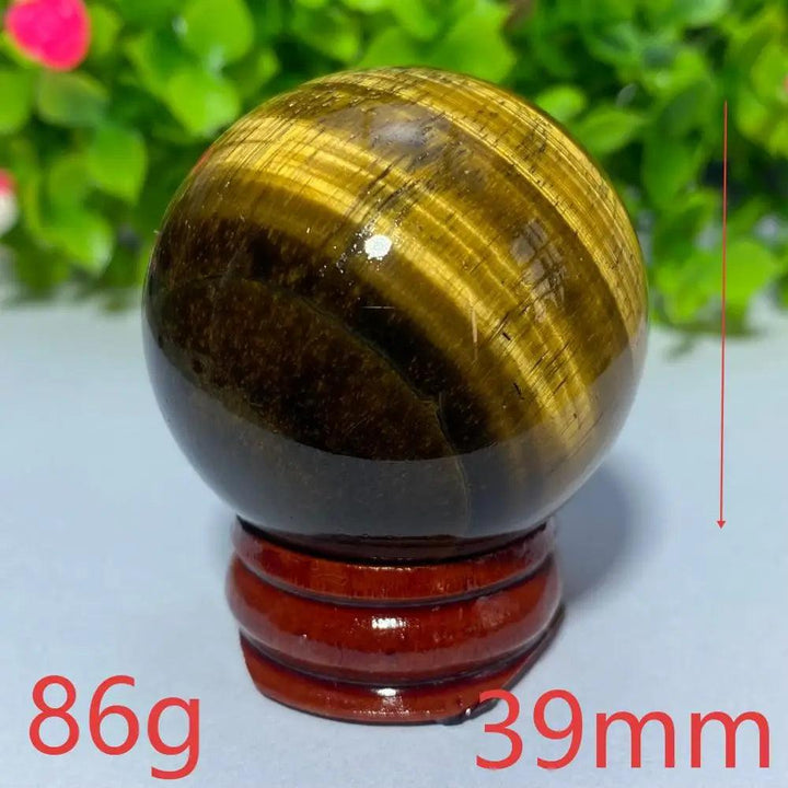 Polished 39mm natural yellow Tiger Eye crystal ball for Reiki healing, meditation, and spiritual home decor.