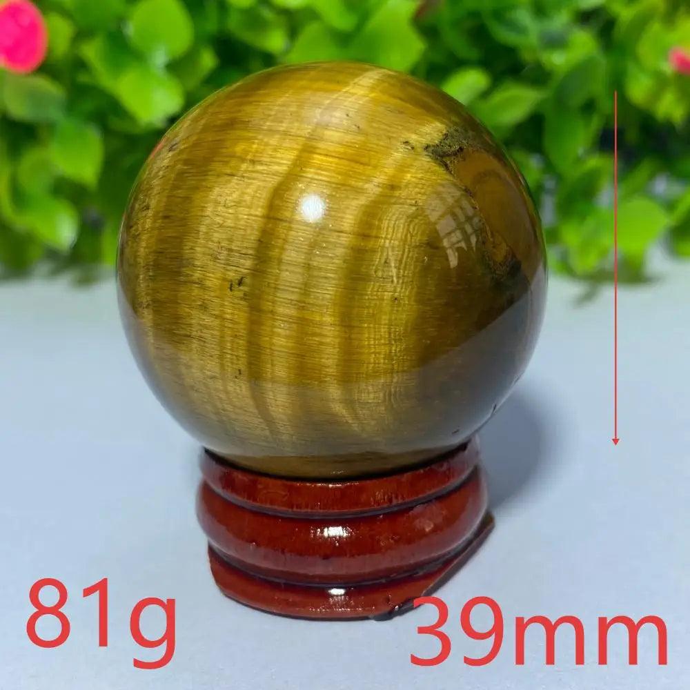 39mm natural yellow tiger eye crystal ball for Reiki healing and meditation, featuring a polished, golden-brown sphere.