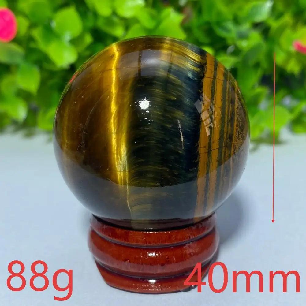 40mm Blue and Yellow Tiger Eye crystal ball for Reiki healing, meditation, and spiritual home decor.
