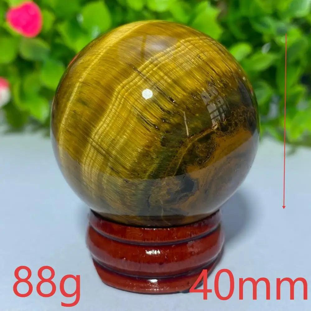 40mm natural yellow Tiger Eye crystal ball on a wooden stand, perfect for Reiki healing, meditation, and home decor.
