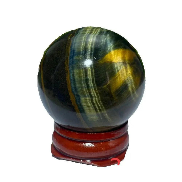 Polished Blue and Yellow Tiger Eye crystal ball on a wooden stand, perfect for Reiki healing and spiritual home decor.