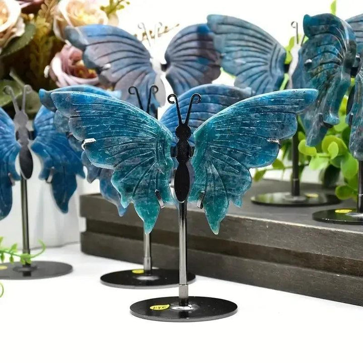Vivid electric teal-blue Apatite butterfly wings crystal carving on a stand, symbolizing transformation and clarity.