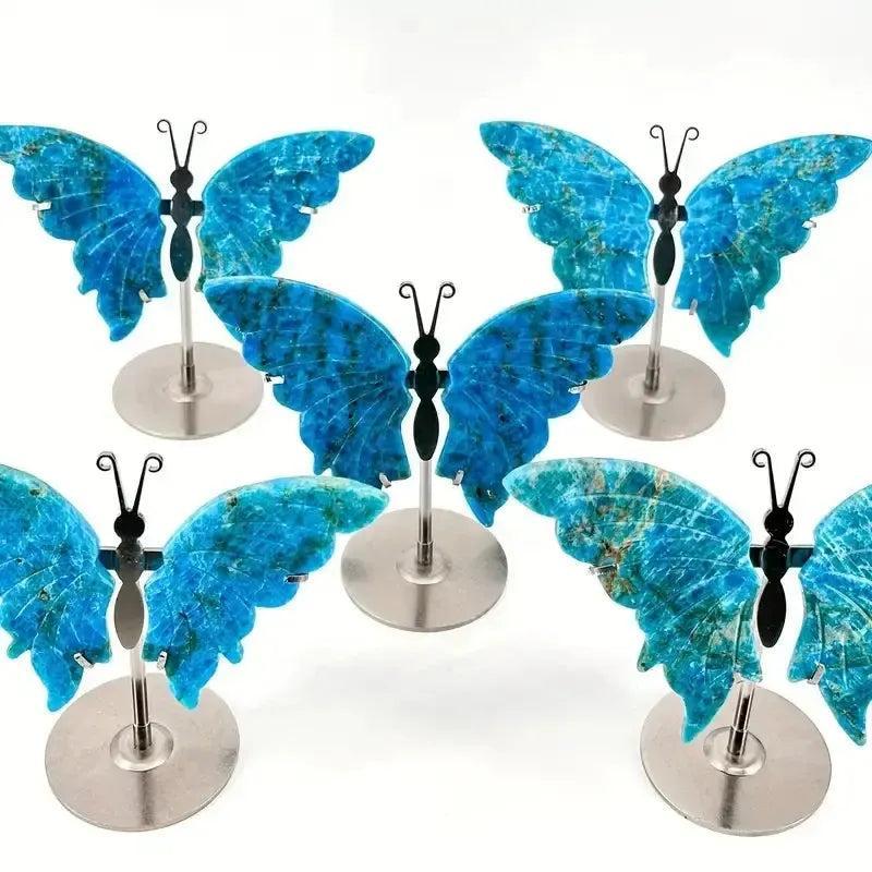 Vivid electric teal-blue Apatite butterfly wings crystal carving on stands, symbolizing transformation and clarity.