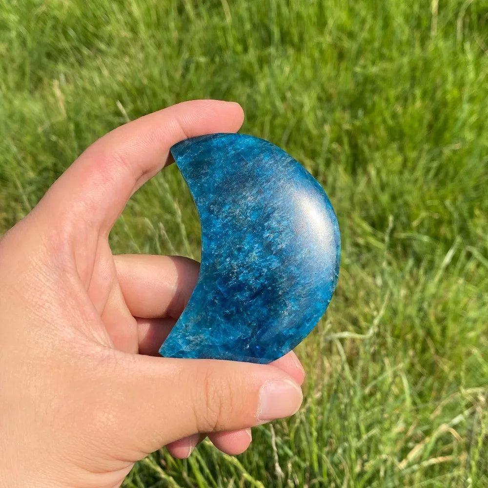 Hand-held Blue Apatite crystal carved moon with vibrant electric blue tones for focus, creativity, and clear energy.