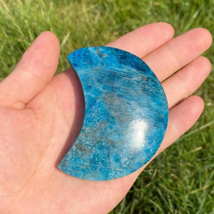 Hand-carved Blue Apatite crescent moon crystal with vibrant electric blue hues for focus, creativity, and inspiration.
