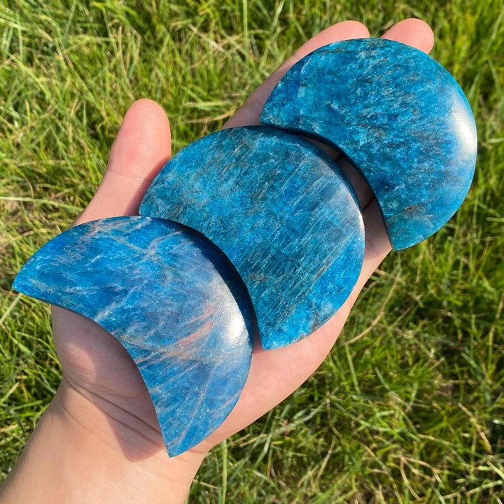 Hand held Blue Apatite crystal carved moons, featuring vibrant electric blue stone for focus, creativity, and clarity.