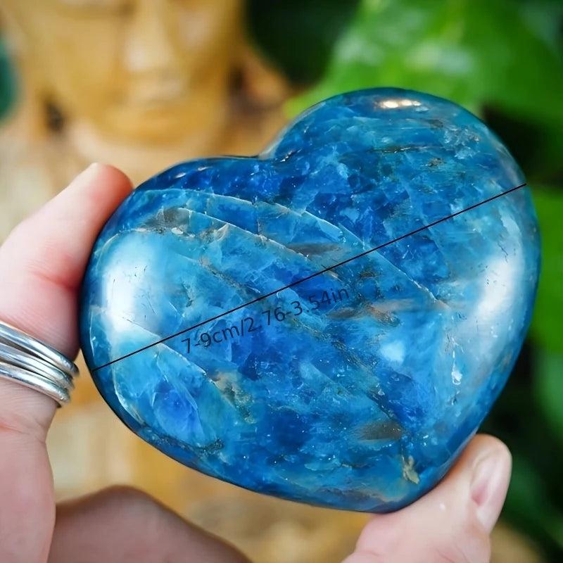 Polished blue apatite crystal heart palm stone with deep teal hues, perfect for meditation and throat chakra healing.