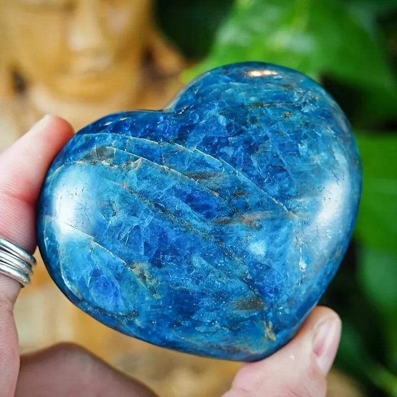 Polished Blue Apatite crystal heart palm stone with deep teal-cobalt hues, perfect for meditation and manifestation.