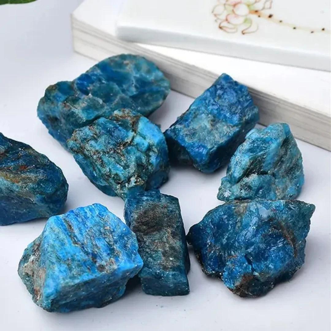 Raw Blue Apatite crystal chunks with vibrant neon blue color, glassy fractures, and natural texture for focus and clarity.
