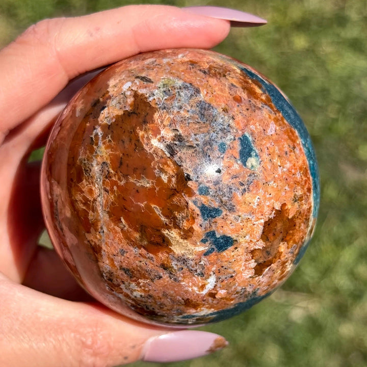 Blue Apatite Sunstone Crystal Sphere in orange and blue for confidence and vitality.