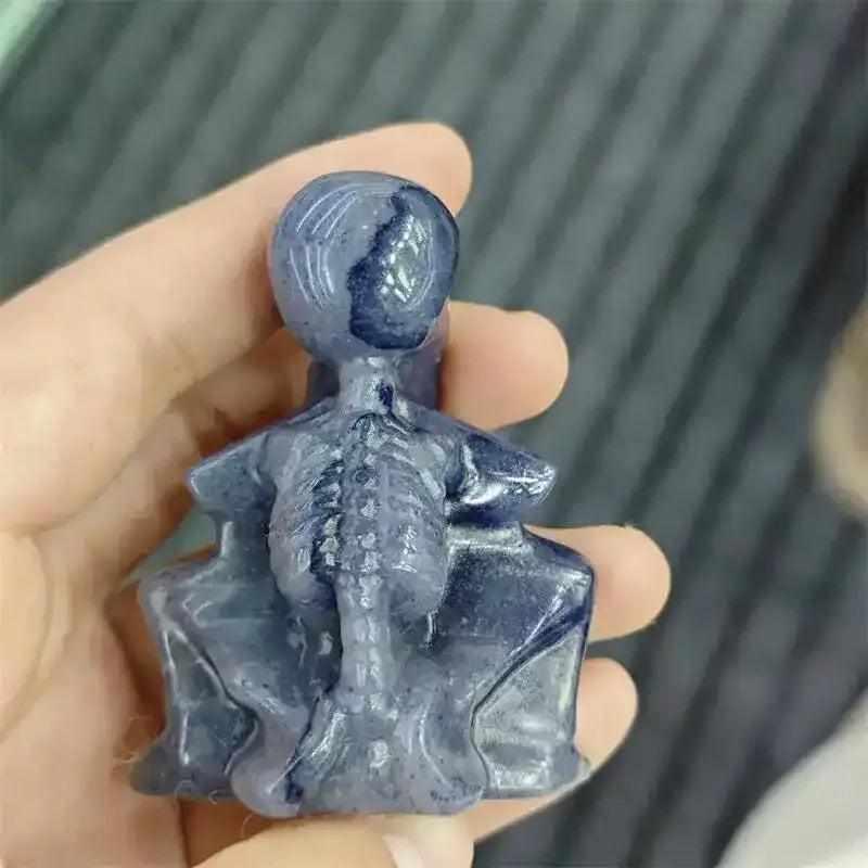 60mm Blue Aventurine skeleton carving with polished blue-gray stone, detailed ribcage, and Throat Chakra energy.