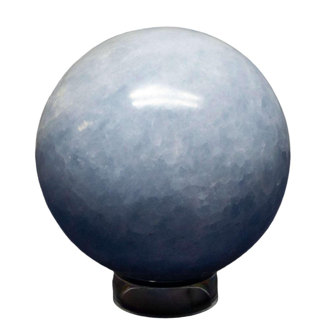 Calming Blue Calcite Sphere, 72-93mm, with hazy blue color, polished smooth for enhanced translucency.