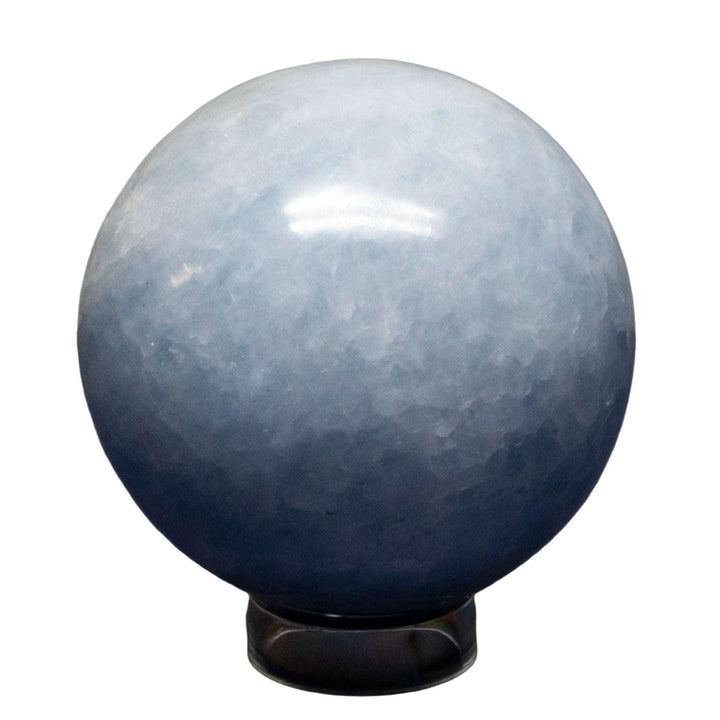 Calming Blue Calcite Sphere, 72-93mm, with hazy blue color, polished smooth for enhanced translucency.