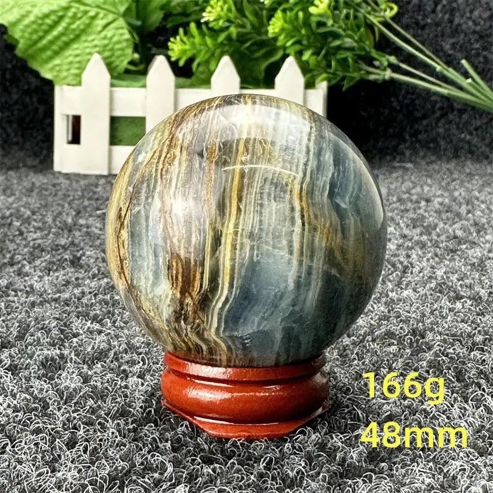 Stunning Blue Calcite Crystal Sphere with serene blue and brown tones, promoting peace and emotional healing.