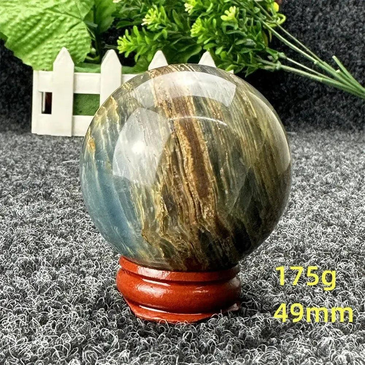 Stunning Blue Calcite Crystal Sphere with serene blue and brown tones, promoting emotional balance and stress relief.