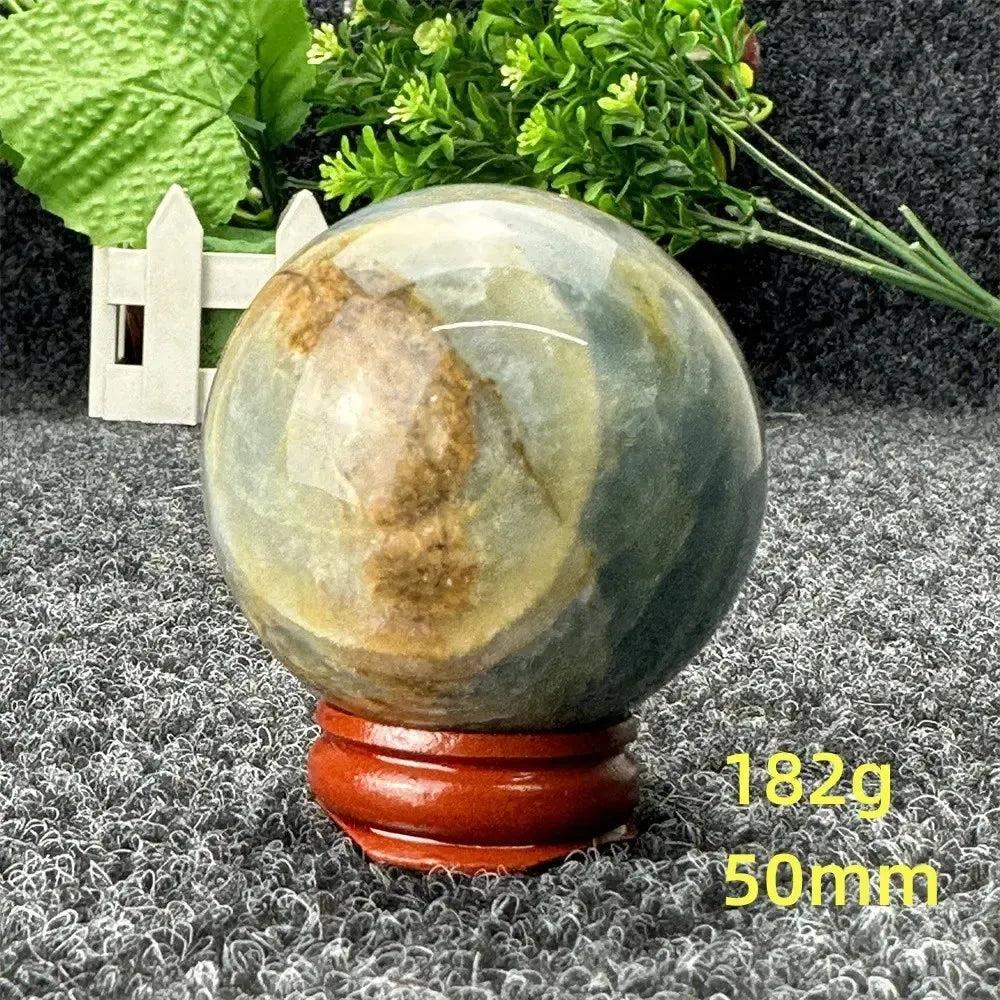 Blue Calcite Crystal Sphere: Serene, hand-polished sphere with gentle blue and brown tones, promoting peace and communication.
