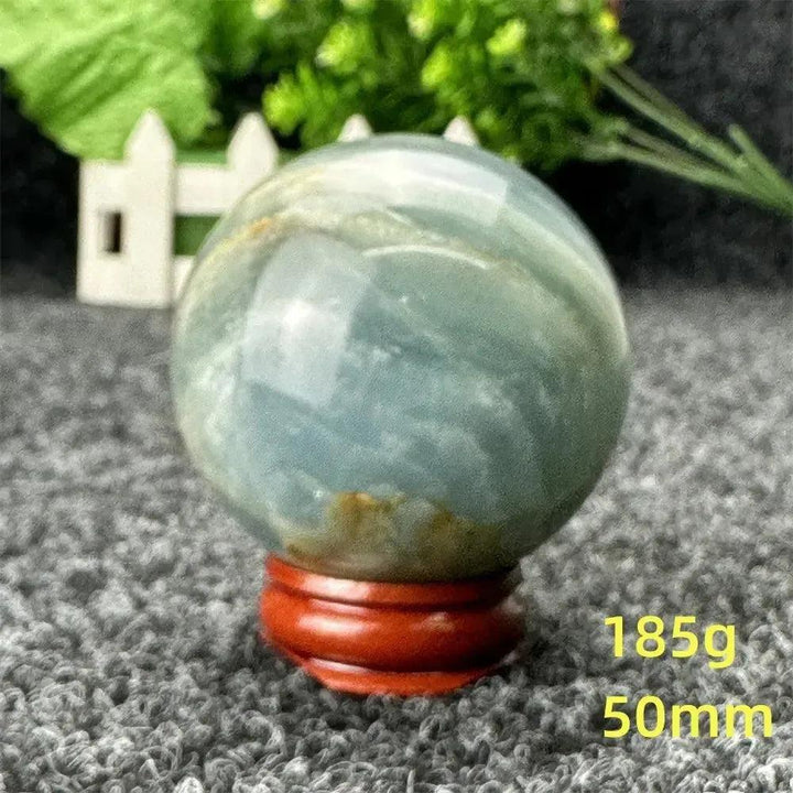 Blue Calcite Crystal Sphere, a stunning, hand-polished sphere with serene blue tones for peace and emotional healing.