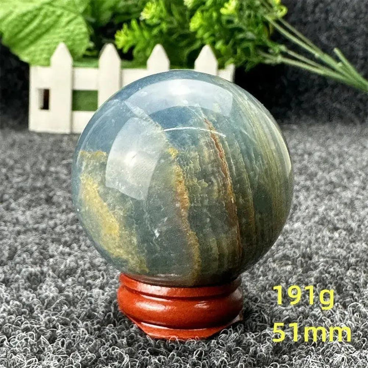 Stunning Blue Calcite Crystal Sphere with serene blue and aqua tones, promoting peace and emotional healing.
