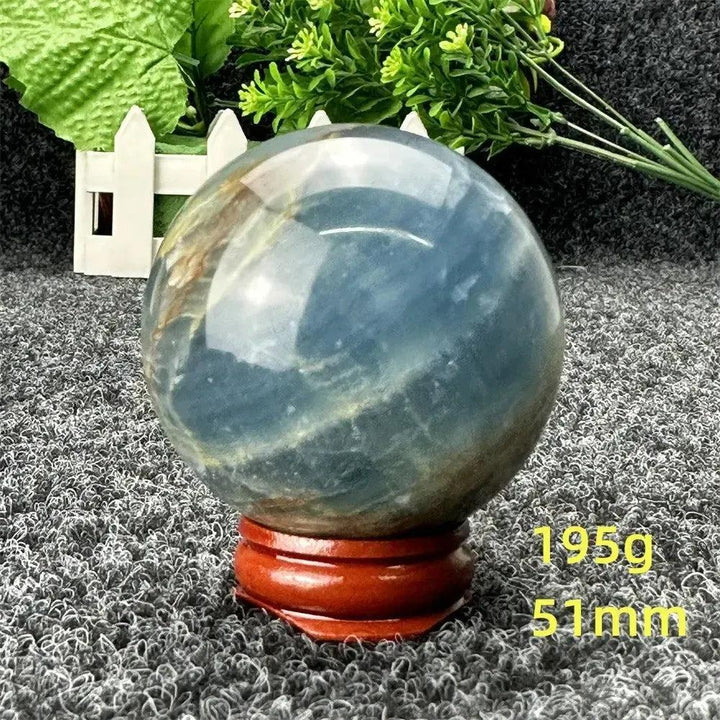 Stunning Blue Calcite Crystal Sphere, 51mm, with serene blue tones, promoting peace and emotional healing.
