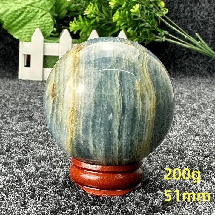 Blue Calcite Crystal Sphere: Serene, hand-polished sphere with soft blue and golden tones, promoting peace and communication.