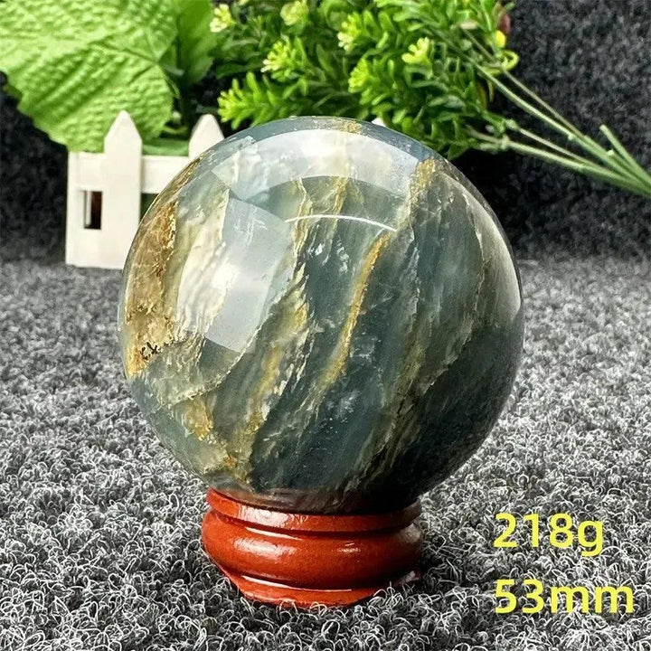 Blue Calcite Crystal Sphere: Stunning 53mm polished sphere with serene blue and gold tones, radiating calming energy.