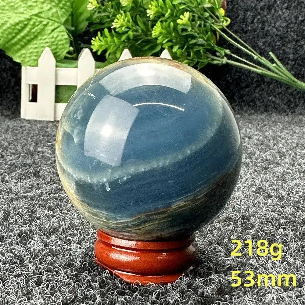 Stunning Blue Calcite Crystal Sphere, 53mm, 218g, with serene blue tones, promoting peace and emotional healing.