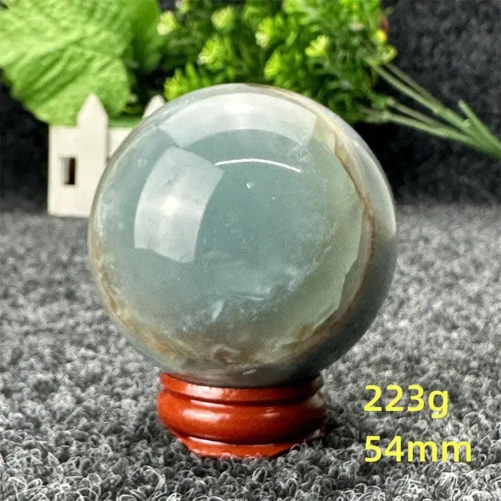 Stunning Blue Calcite Crystal Sphere, 223g, 54mm. Serene blue-green hues evoke peace and emotional healing.