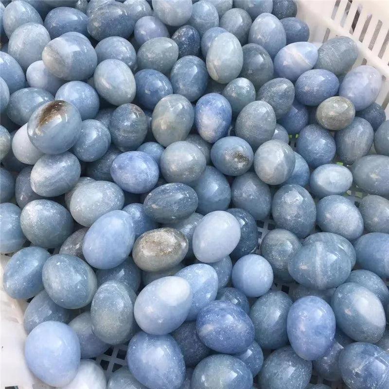 Basket filled with numerous polished Blue Celestite crystal eggs, radiating peace and calm.