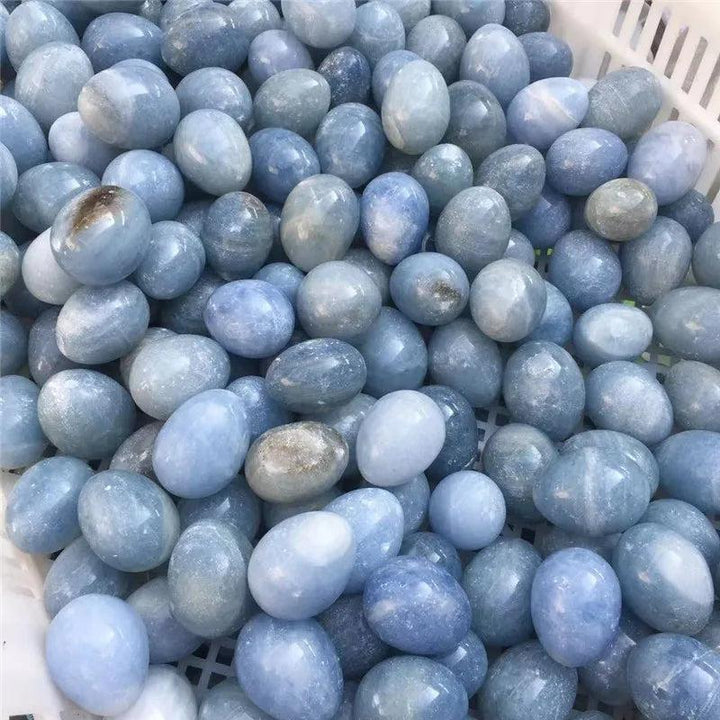 Basket filled with numerous polished Blue Celestite crystal eggs, radiating peace and calm.