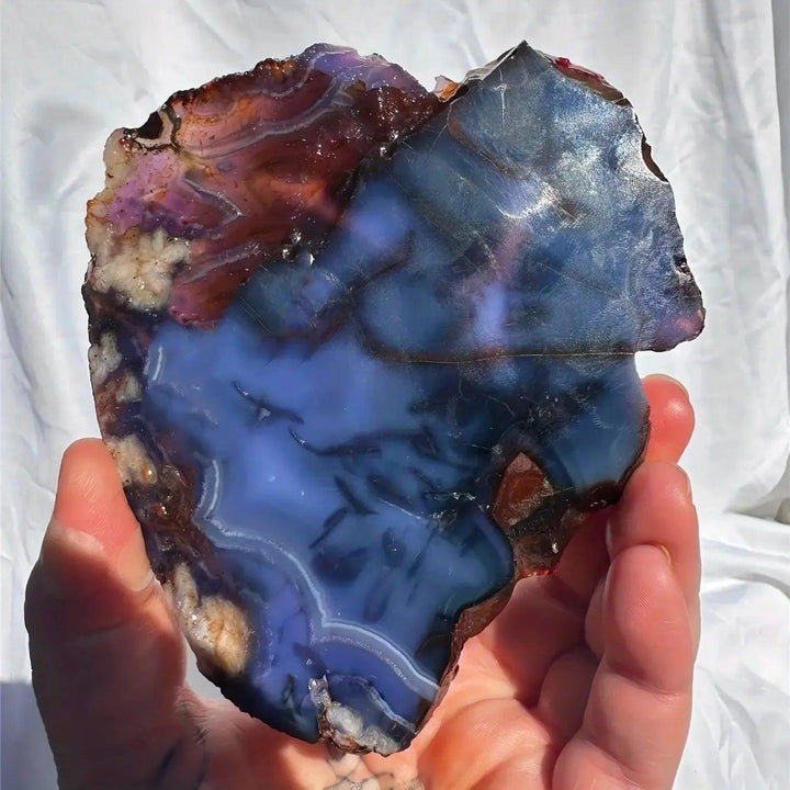 Blue Flower Agate Crystal Slab with deep ocean blues, creamy beige cherry blossom patterns, and a raw edge.