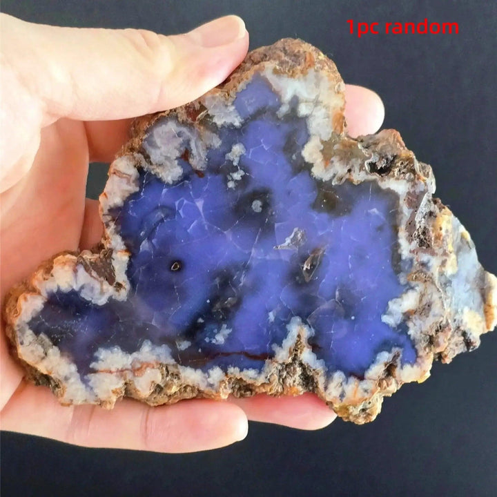 Hand holding a vibrant blue flower agate crystal slab with cherry blossom patterns and natural edges from Crystal Destiny.