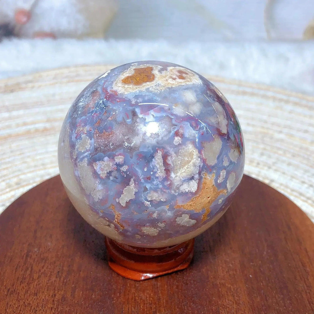 Blue Flower Agate Crystal Sphere from Crystal Destiny, featuring delicate blue, white, and brown floral patterns.