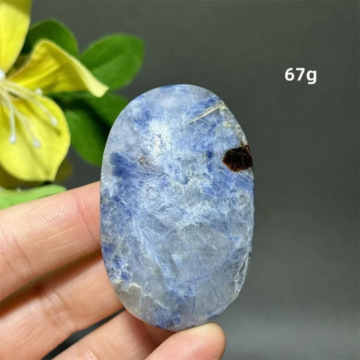 Polished 67g blue kyanite palm stone with striated indigo ribbons for grounding, peace, and throat chakra healing.