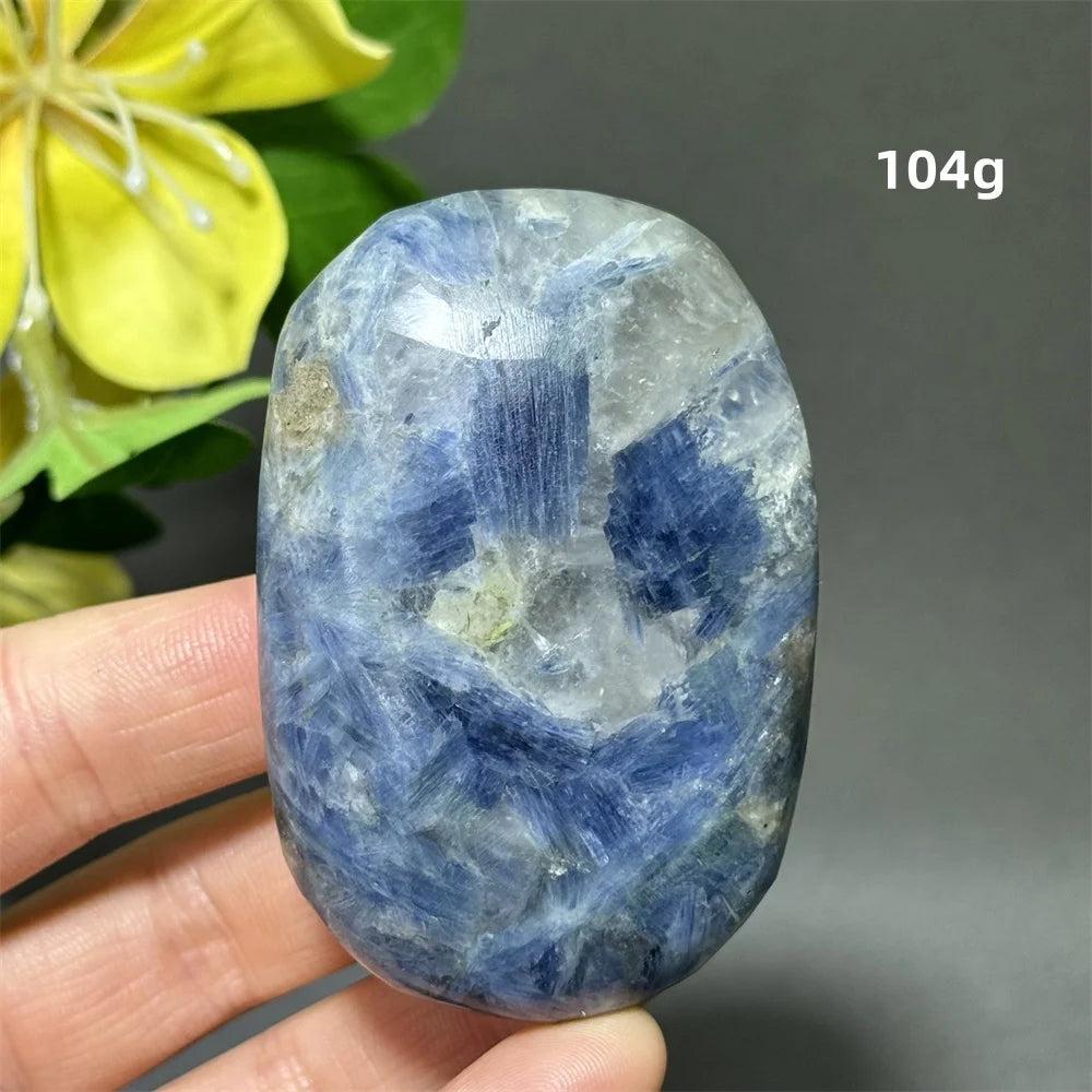 Polished 104g Blue Kyanite palm stone with deep blue striated banding for meditation, peace, and throat chakra healing.