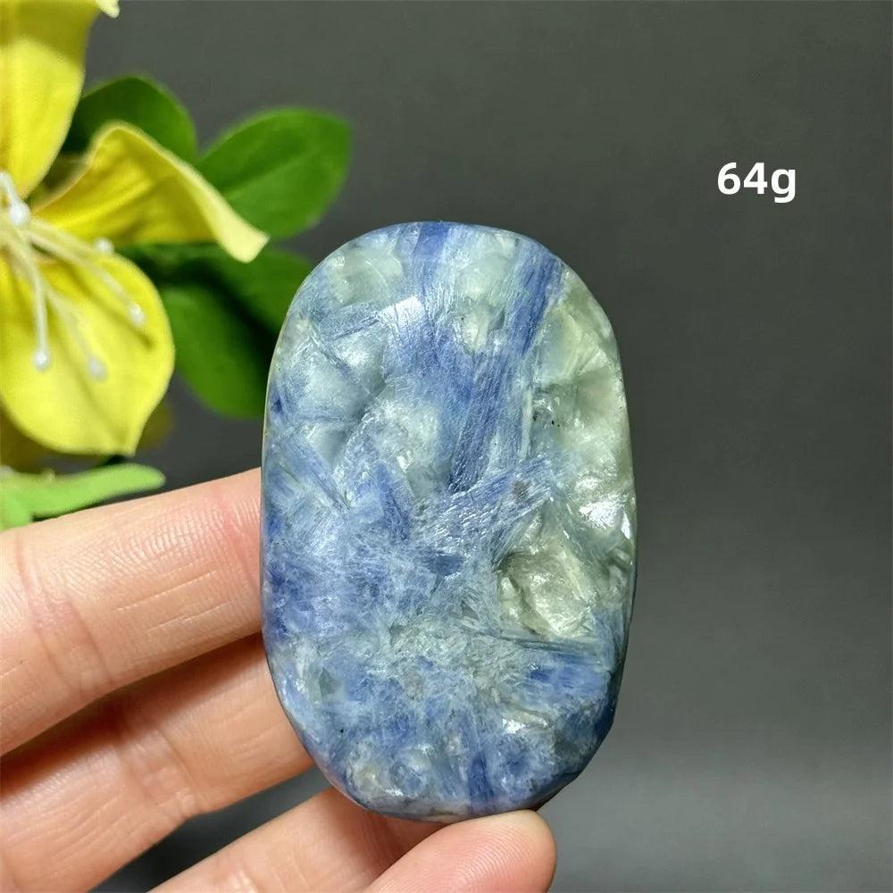 Polished 64g blue kyanite palm stone with deep striated blue ribbons for meditation, grounding, and chakra healing.