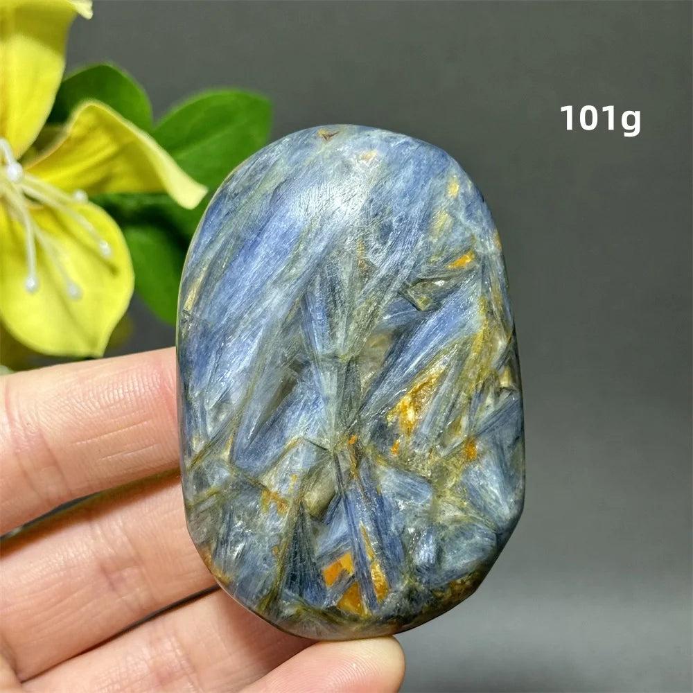 Polished 101g blue kyanite palm stone with deep striated blue ribbons for grounding, peace, and chakra healing.