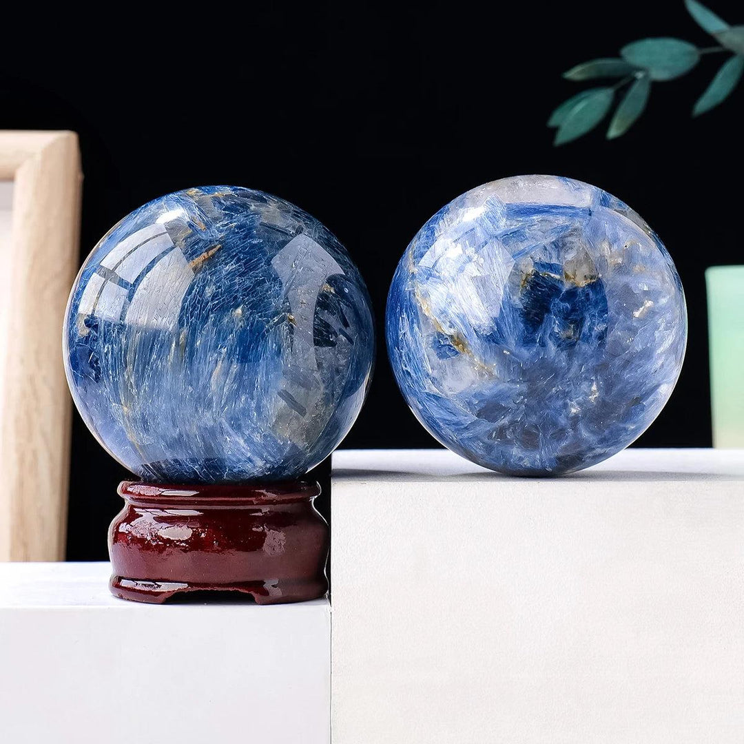 Polished Blue Kyanite crystal spheres with deep blue, striated patterns for energetic balance and throat chakra healing.