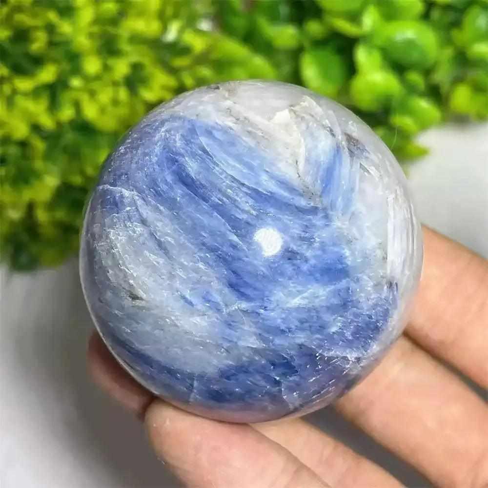 Polished Blue Kyanite crystal sphere with vibrant blue and white patterns for Throat Chakra reflection and mindfulness.