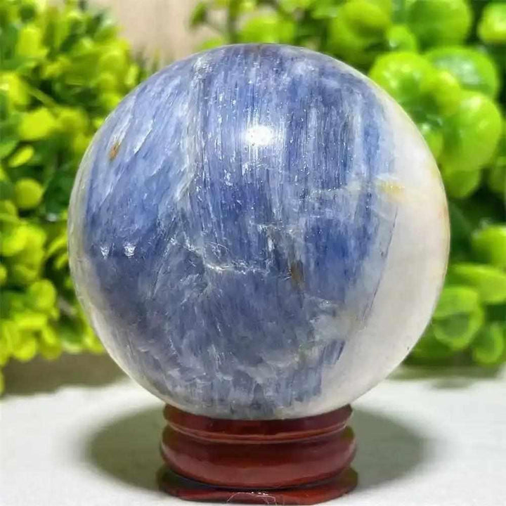 Polished Blue Kyanite crystal sphere with deep blue streaks, perfect for Throat Chakra reflection and mindful intention.