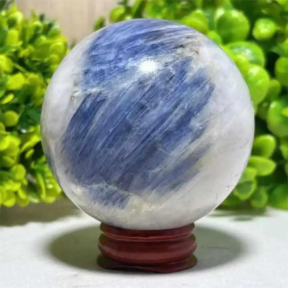 Polished Blue Kyanite crystal sphere with blue and white streaks, perfect for Throat Chakra reflection and mindful decor.