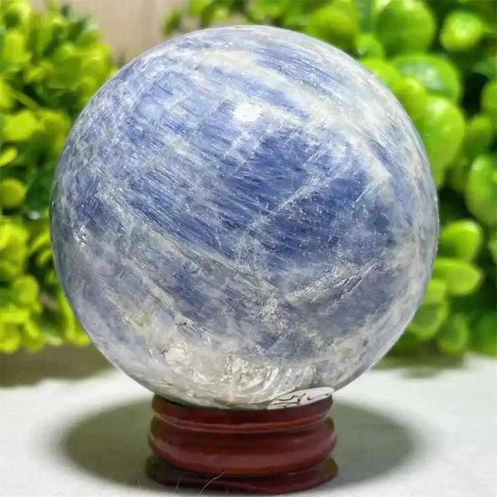 Polished blue kyanite crystal sphere with natural white veining, perfect for Throat Chakra reflection and mindful focus.